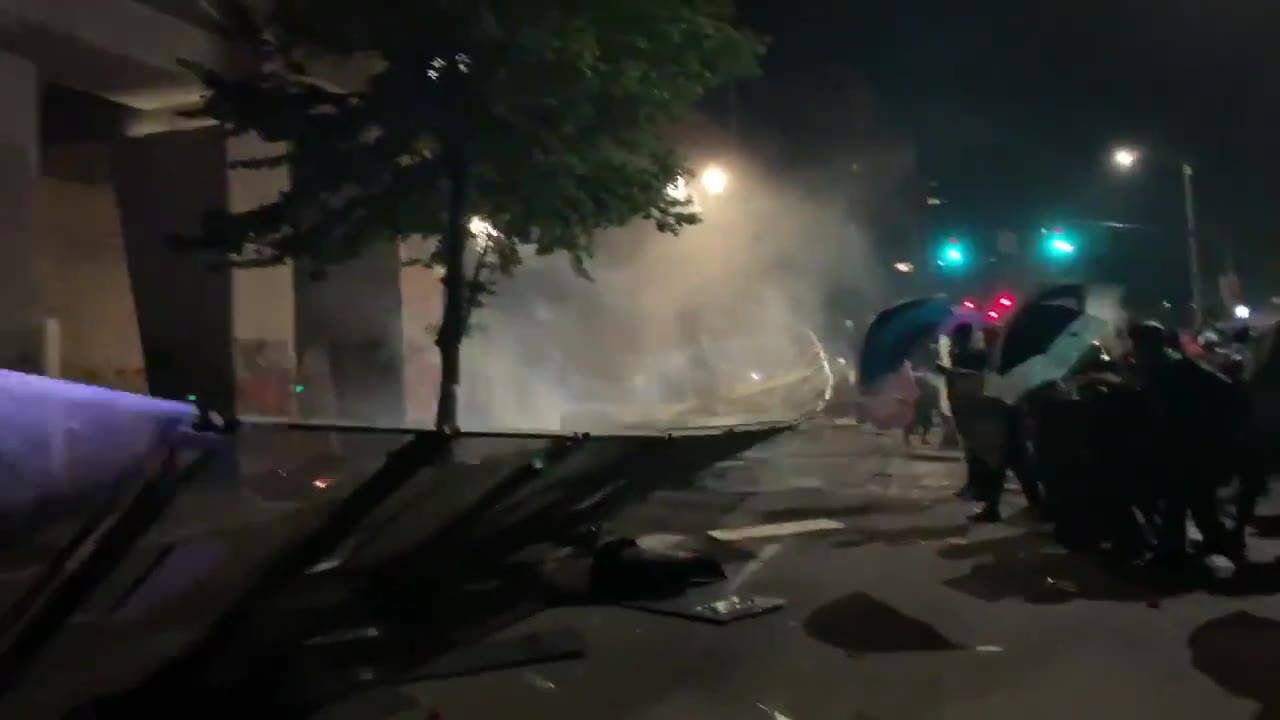 Rioters finally took down the fence, prompting a police...